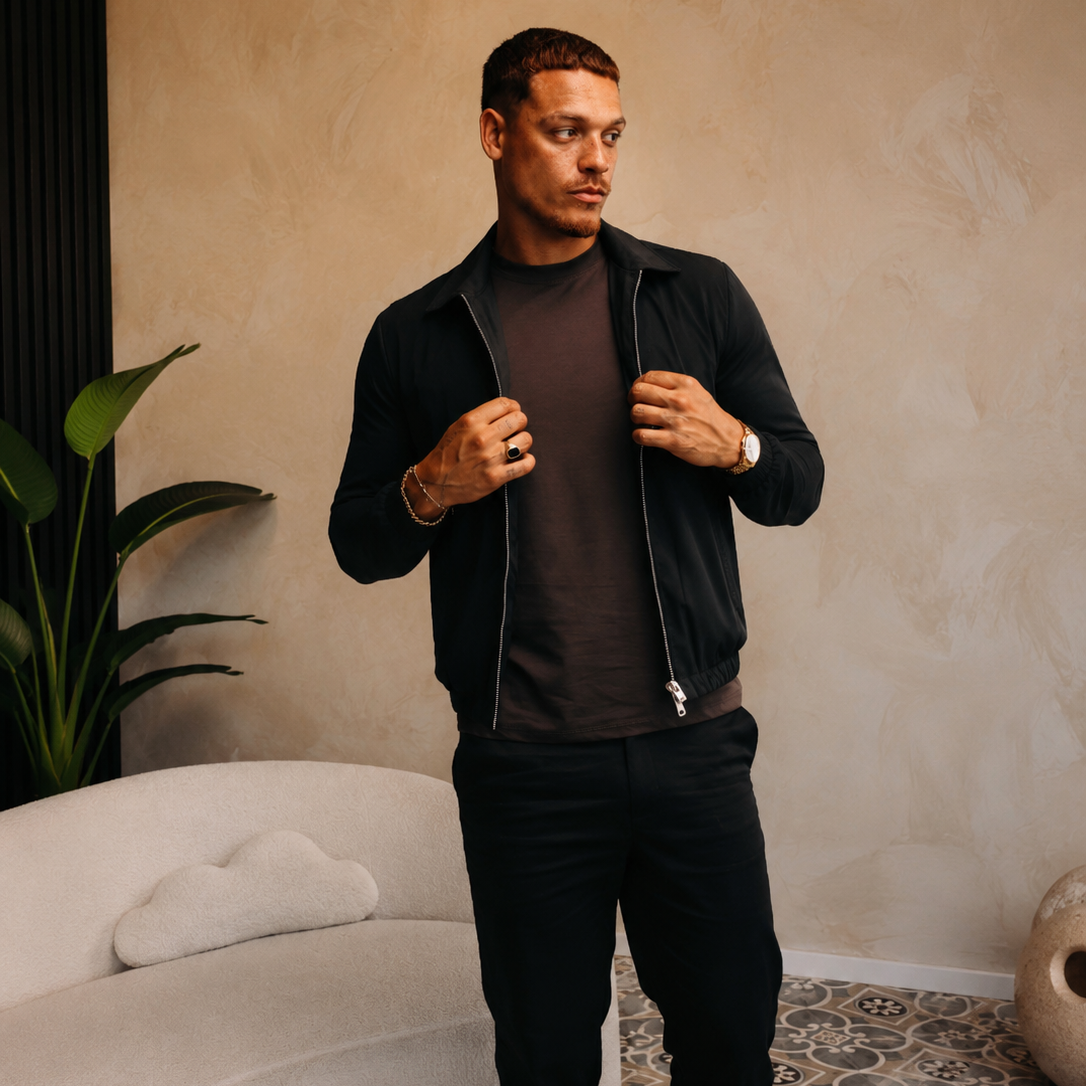 Model in de Smart Jacket in earth over een bruin T-shirt met een zwarte broek